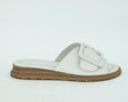 side view of Tyche Monroe leather slide with buckle in cream