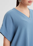 close up front view of Mat plus size air-wash textured polyester Short Sleeve V-Neck top in Indigo