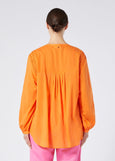 back view of Marina Rinaldi Mira Pleated Tuck Front cotton Peasant Blouse with Liner on model in Orange