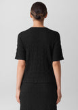 back view of plus size Eileen Fisher Bubble Texture Crew Neck Snug Top in Black