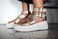 top view of Minx Plaza Platform with Ankle Strap in Soft Gold on model