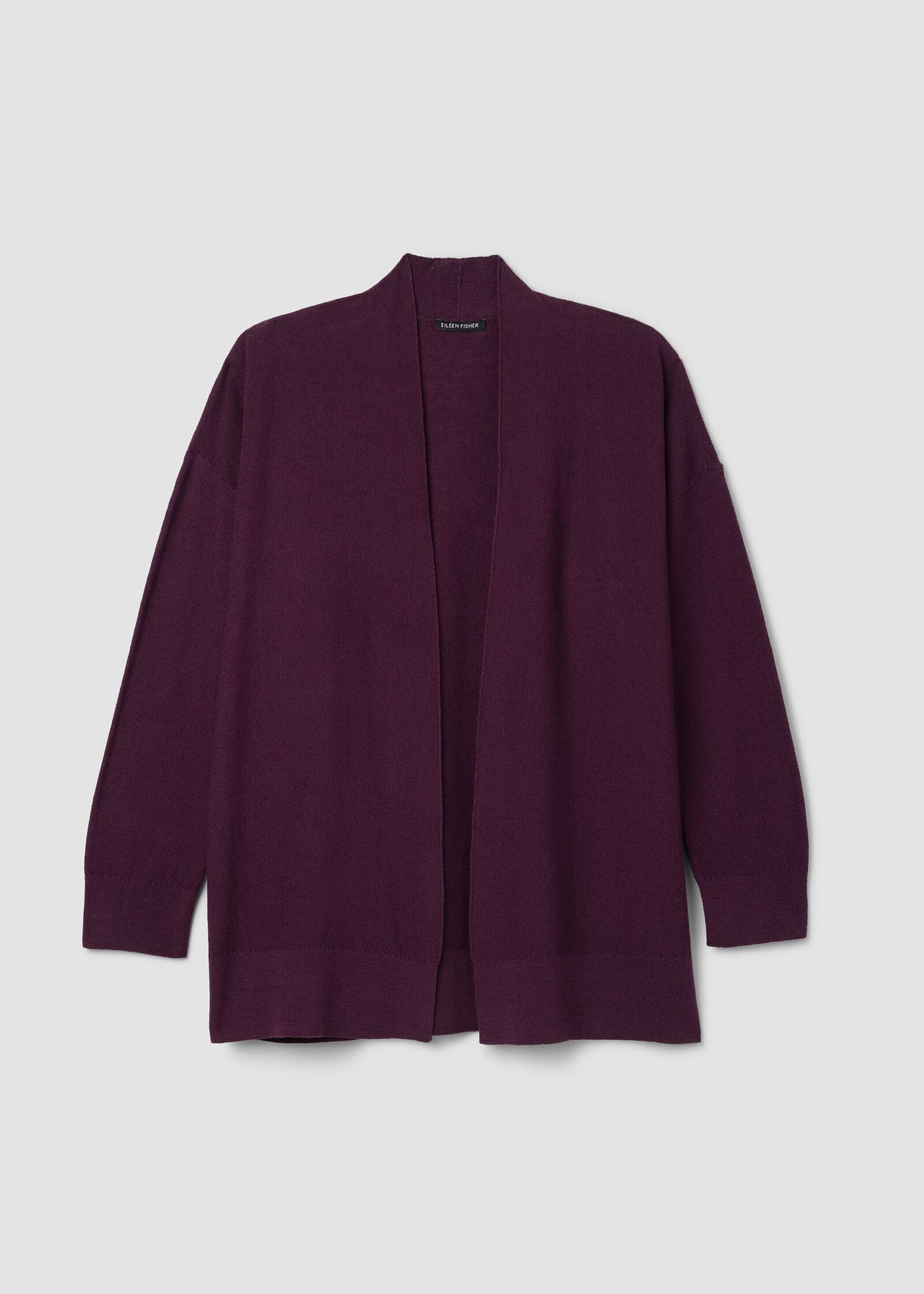 Eileen Fisher Purple cardigan on a light gray background