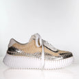 side view of Minx Titch Woven with Leather and Stitch Trim in Gold Metallic