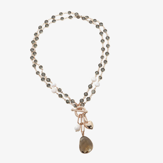 Gold-tone stone bead necklace with faux pearls and hanging brown teardrop charm