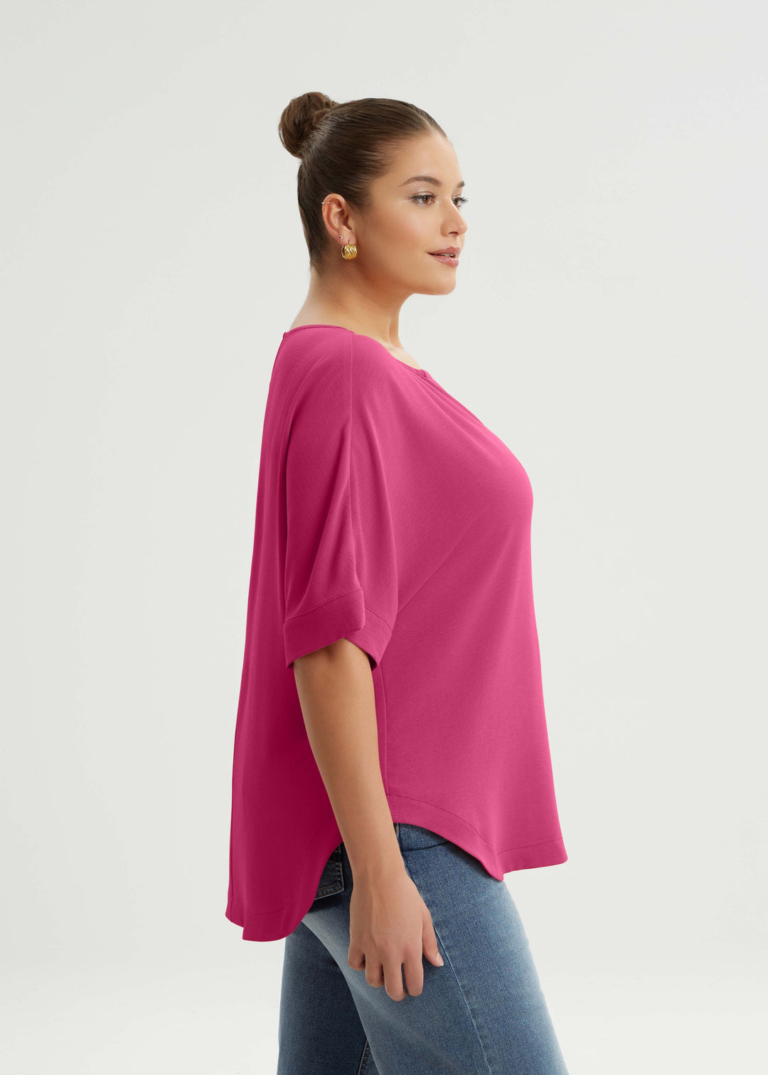 side view of Mat plus size txtured polyester air-wash Split Neck Curved Hem Top in Fuchsia