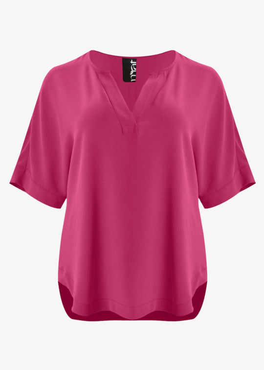 front view of Mat plus size txtured polyester air-wash Split Neck Curved Hem Top in Fuchsia