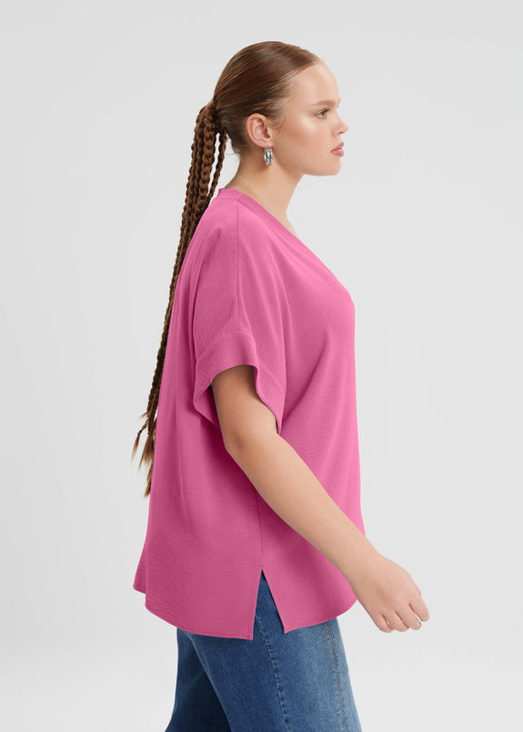 side view of Mat plus size air-wash textured polyester Short Sleeve V-Neck top in Bright Pink