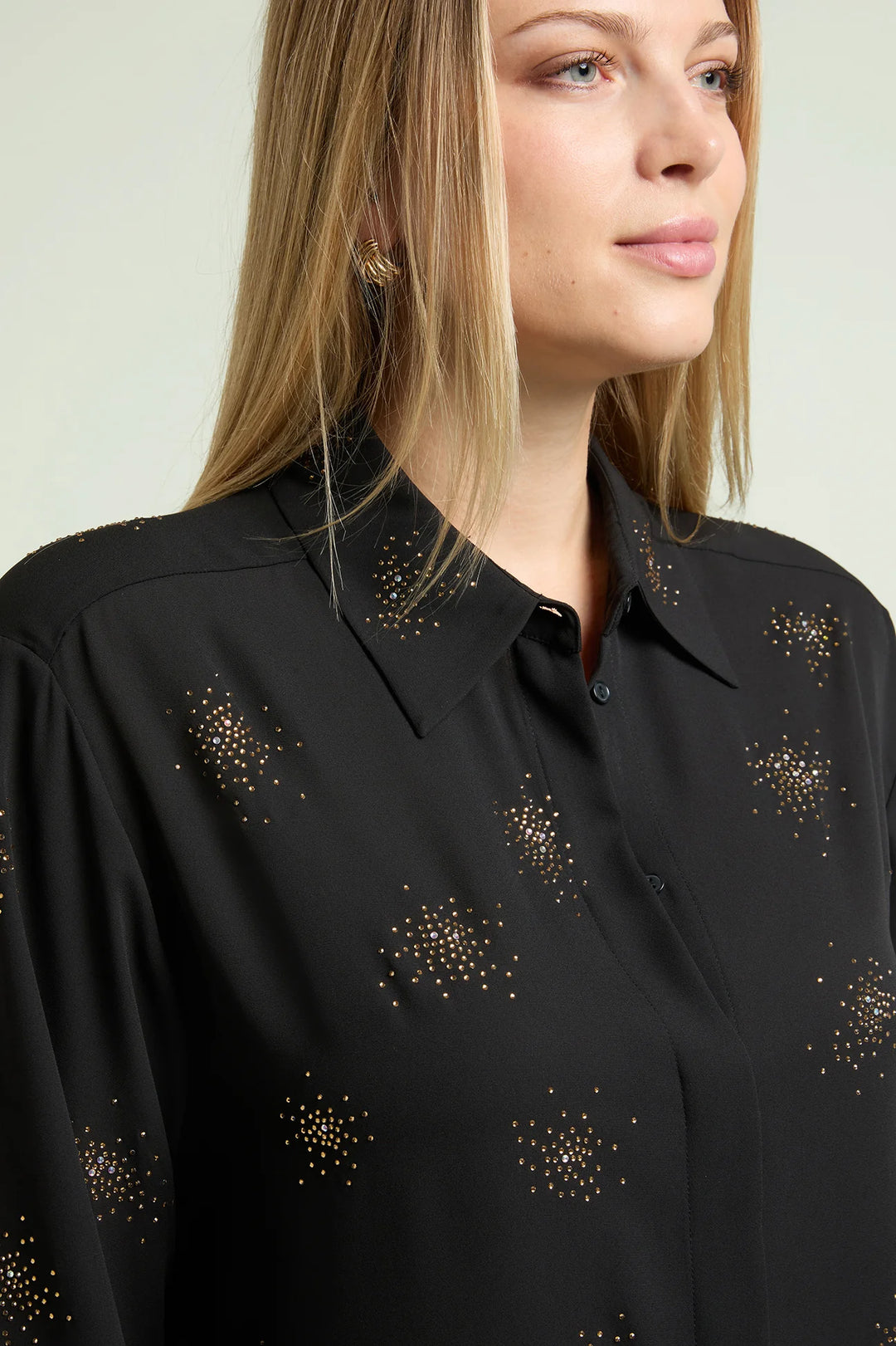 Black long-sleeve blouse with starburst beaded accents at collar and shoulders