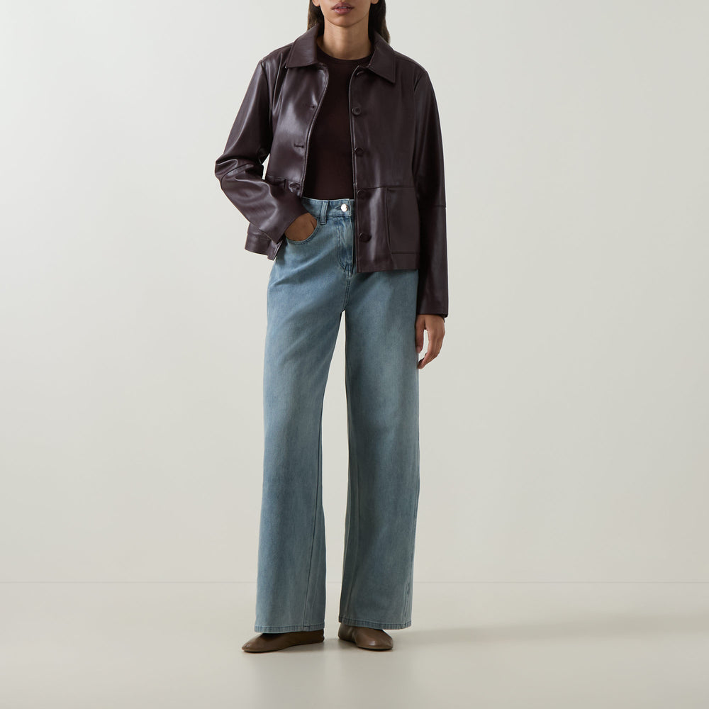 Faux leather button-front jacket in must, stand collar, full sleeves, button placket.