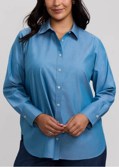 Woman wearing a blue shirt against a plain background