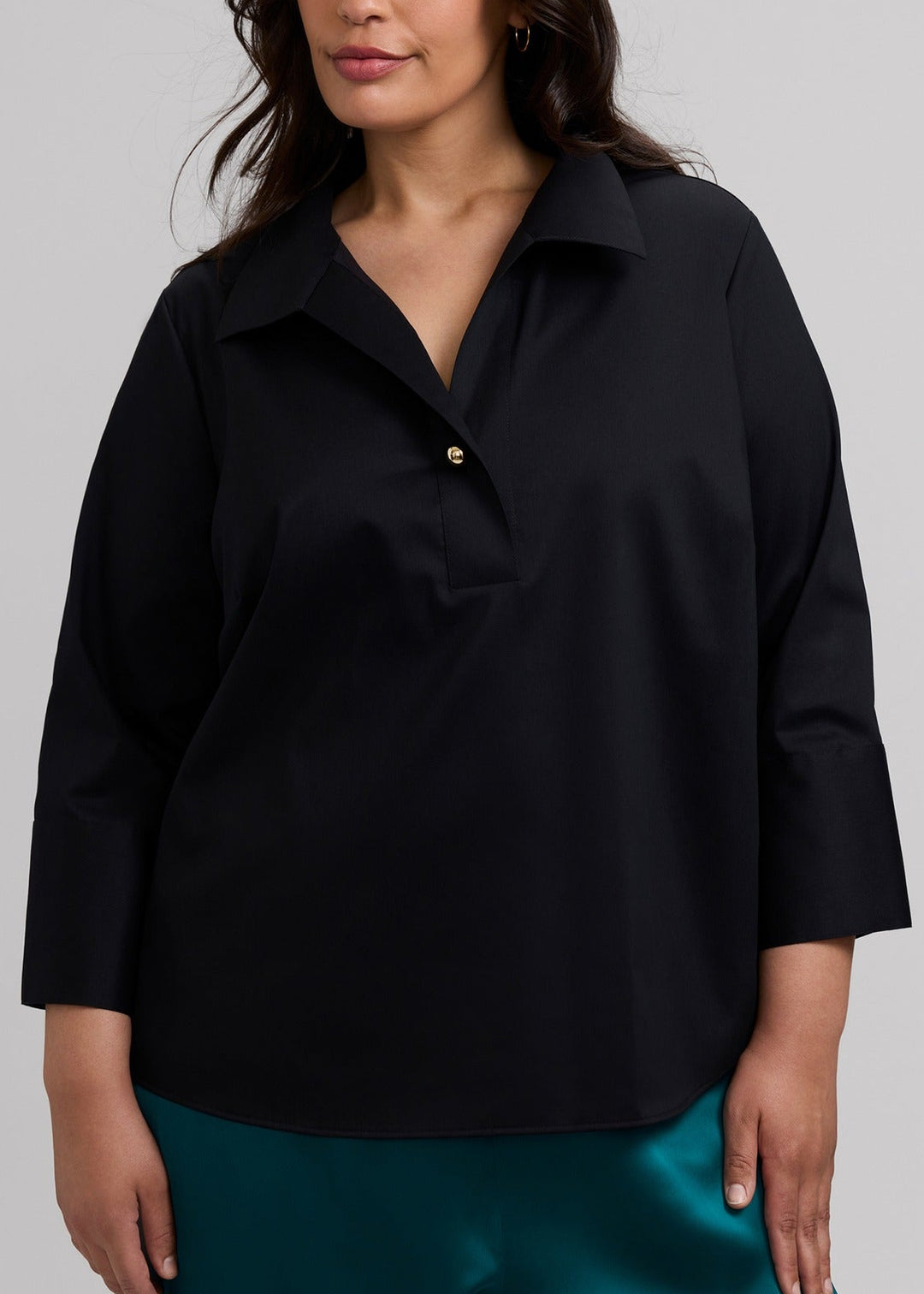 Women's black popover blouse with 3/4 sleeves, button front, and gold accents