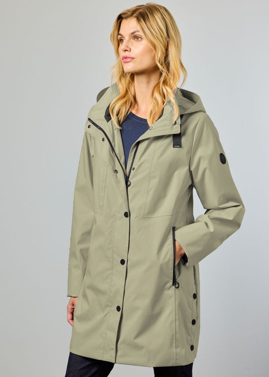 Woman wearing a green raincoat against a gray background