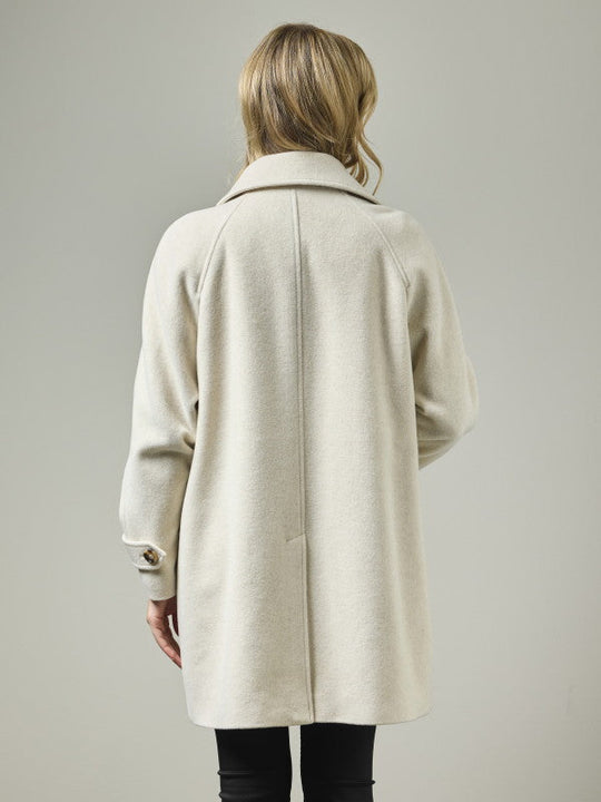 Wool blend A-line coat with raglan shoulders shown from back on model, light oatmeal color