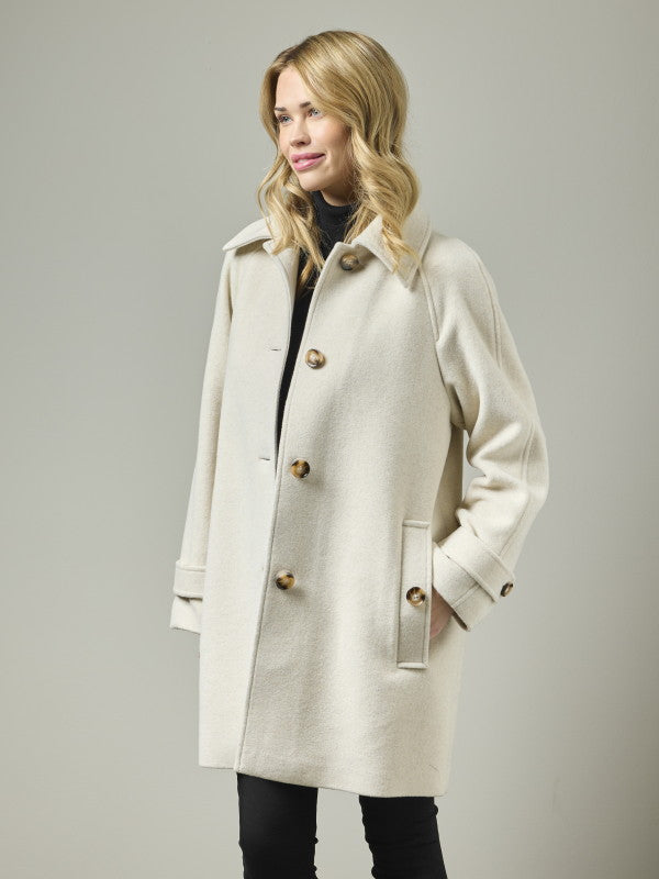Cream wool blend A-line coat with tortoiseshell buttons, raglan sleeves, and epaulette detail, front angle view