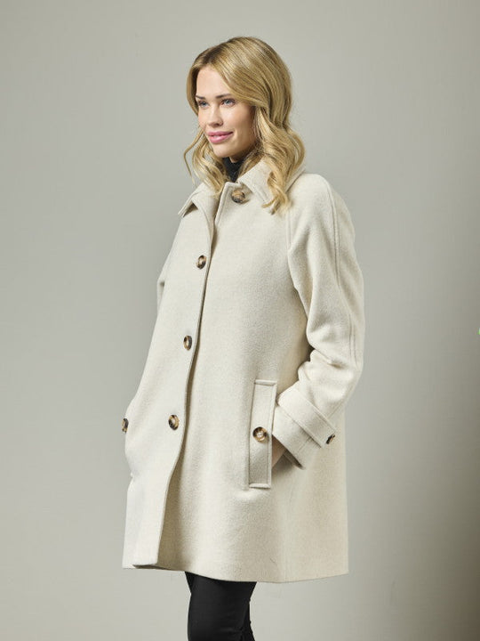 Cream wool blend A-line coat with button front, high collar, and epaulette sleeve detail, side view