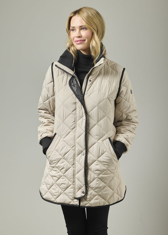 Almond quilted knee-length coat, stand knit collar, front zip, contrast trim, storm cuffs