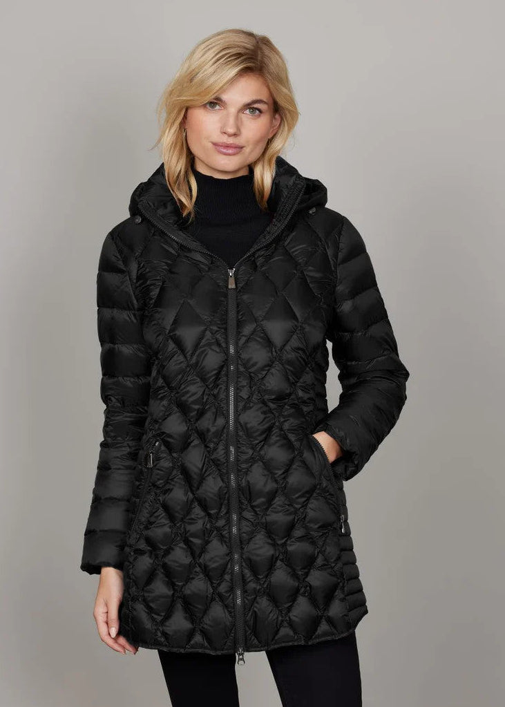 Woman wearing a black quilted jacket against a gray background