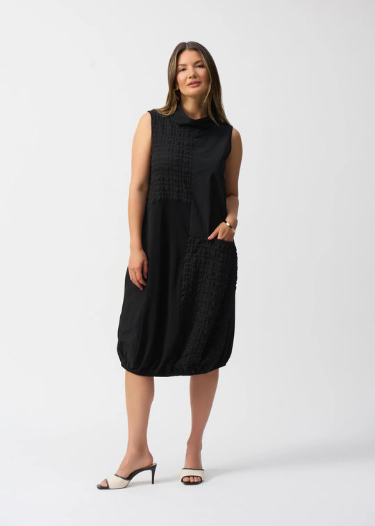 front view of plus size Joseph Ribkoff Bubble Jacquard Sleeveless Mixed Media Cocoon Dress in Black