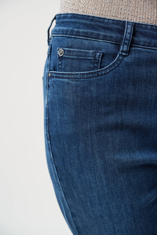 Medium blue denim jeans showing front pocket detail and slim fit silhouette