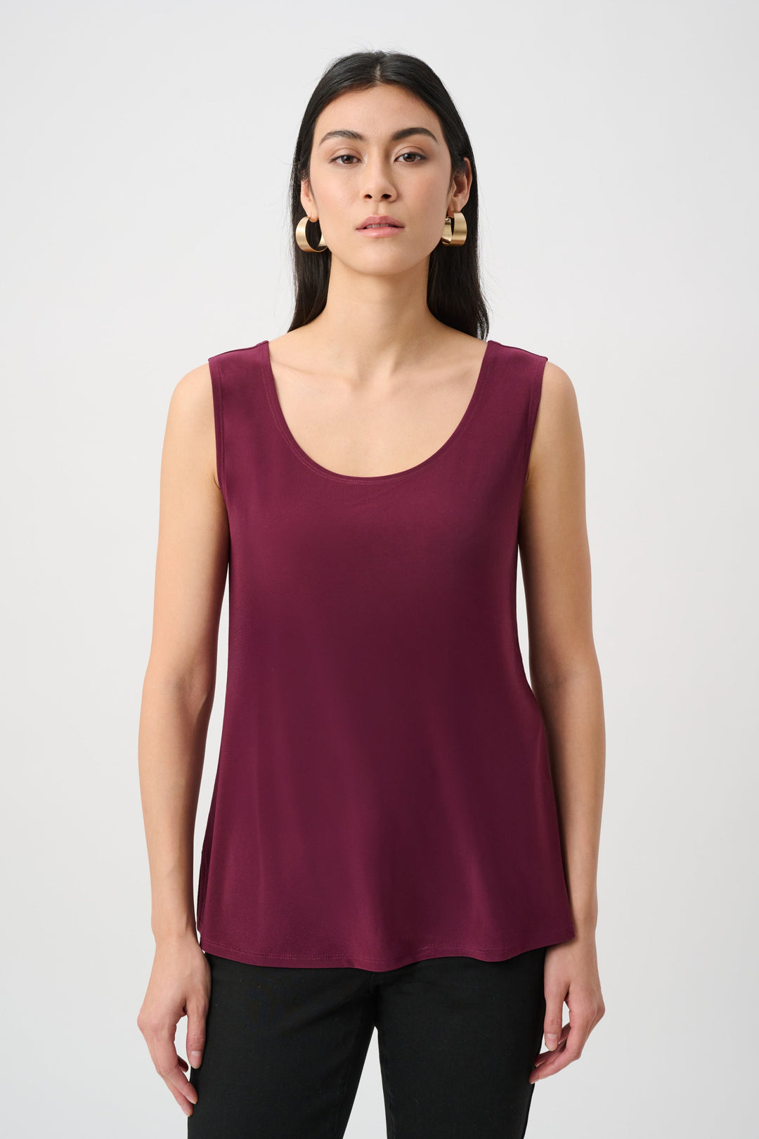 Wine-purple silky knit scoop-neck cami, sleeveless with flowy straight hem.