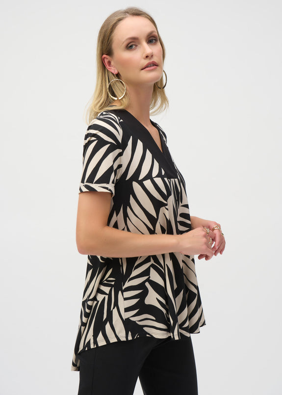 front view of plus size Joseph Ribkoff Jersey Knit Tropical Print Flared Top in Blk/Moonstone