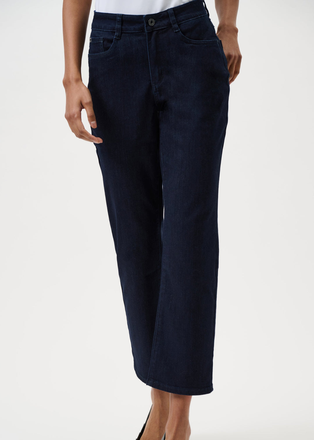 Navy blue pants worn by a person on a white background