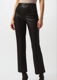 Person wearing black leather pants on a white background