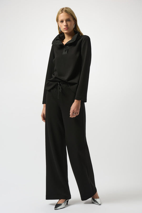 Black wide leg pull-on pants worn by model with matching black top