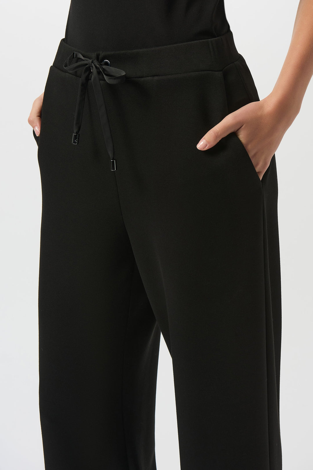 Black wide leg pull-on pants with drawstring waist and side pockets on model
