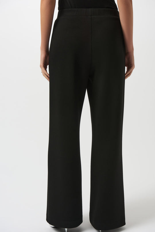 Black wide leg pull-on pants shown from back view on model