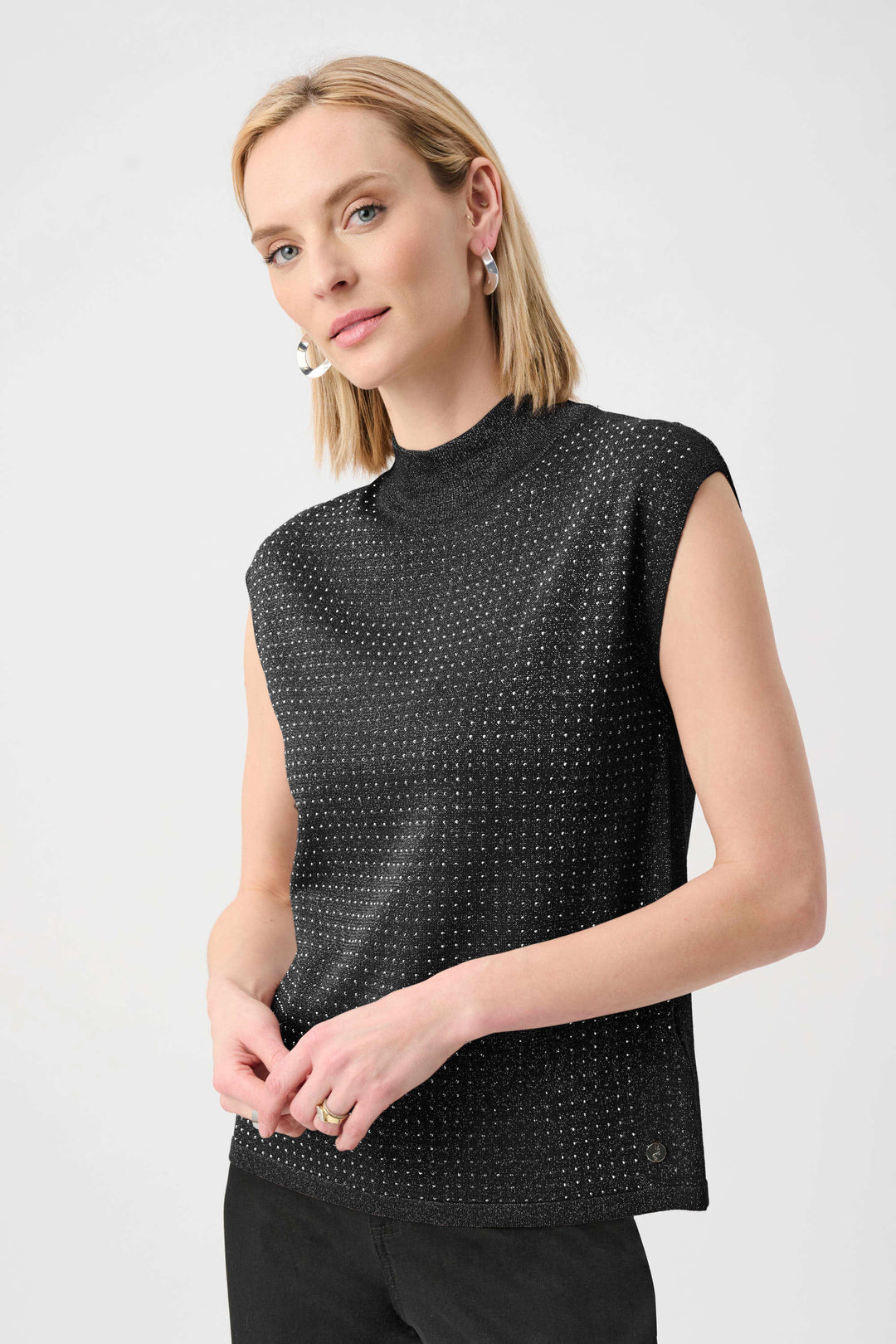 Black sleeveless mock-neck sweater with textured dotted iron-on detail, side view