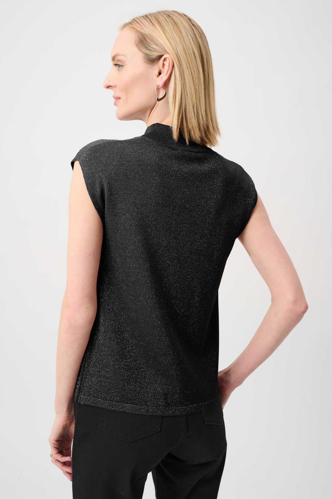 Black sleeveless mock-neck sweater, back view with dotted iron-on textured finish