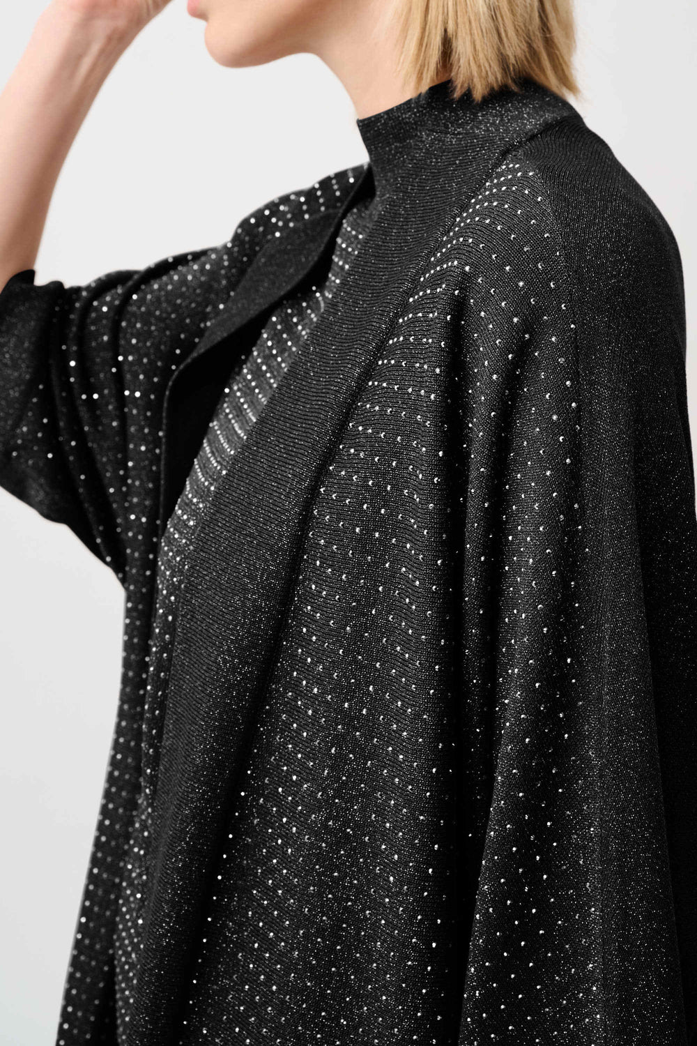 Black knit cardigan with dotted iron-on detail on shoulder and upper back