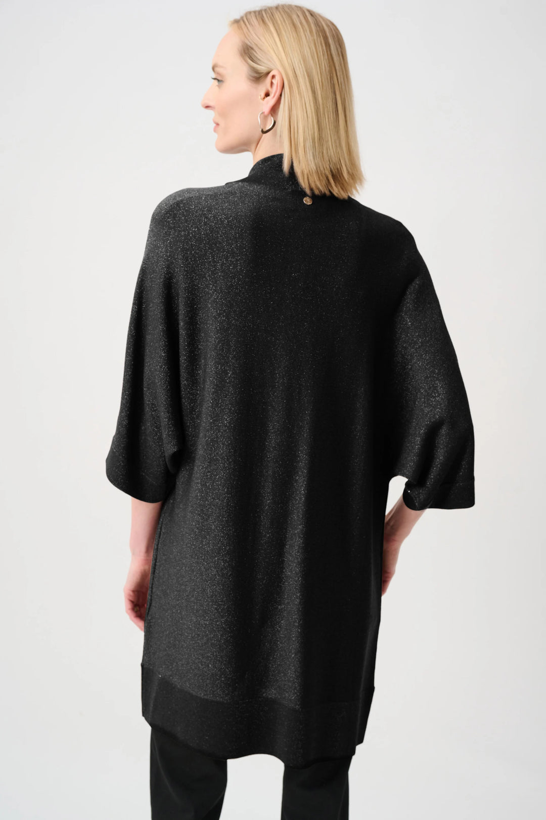 Black knit open cardigan back view, short wide sleeves and iron-on detail