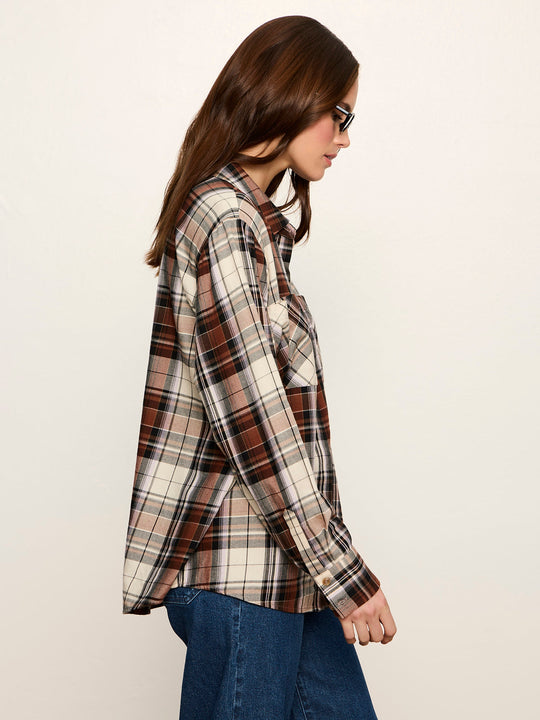 Side view of long-sleeve plaid button-up shirt with chest pocket, worn with jeans
