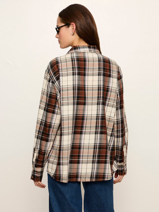 Oversized plaid flannel shirt in cream and brown tones, back view on model with jeans
