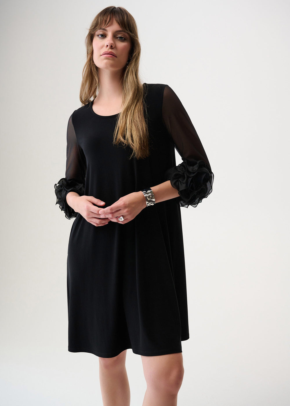 front view of plus size Joseph Ribkoff Jersey Mesh Swing Dress with Ruffle Trim in Black