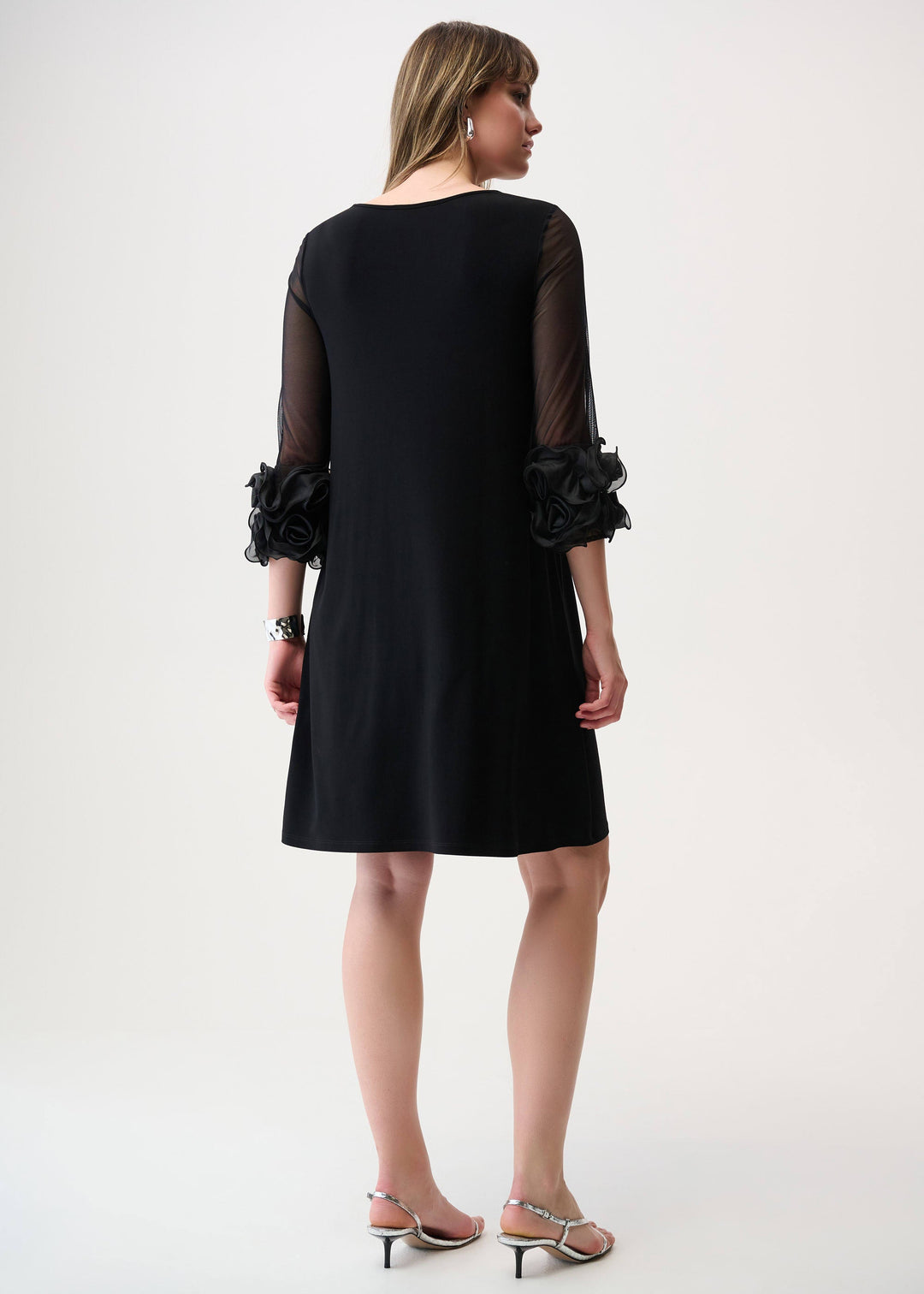 back view of plus size Joseph Ribkoff Jersey Mesh Swing Dress with Ruffle Trim in Black