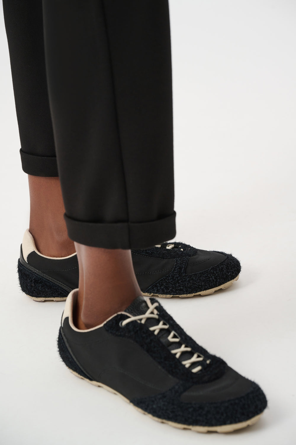 Black jogger pants with elastic cuffs and smooth scuba-jersey fabric