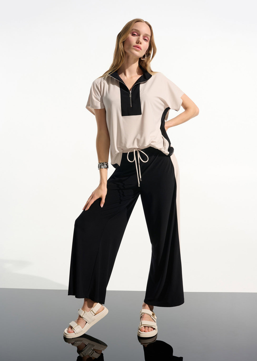 front view of plus size Joseph Ribkoff silky Knit Colour Block S/S Top with Zip Neck in Moonstone Black