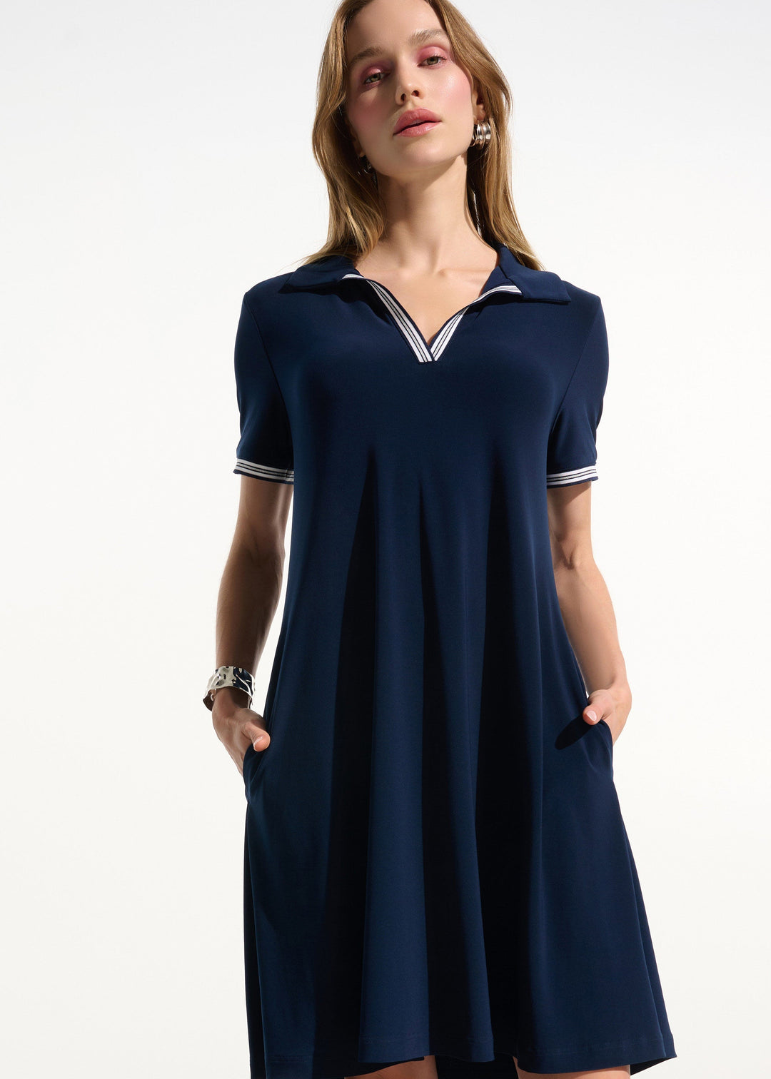 front view of plus size Joseph Ribkoff Silky Knit Trapeze Tennis Dress with Polo Collar in Indigo