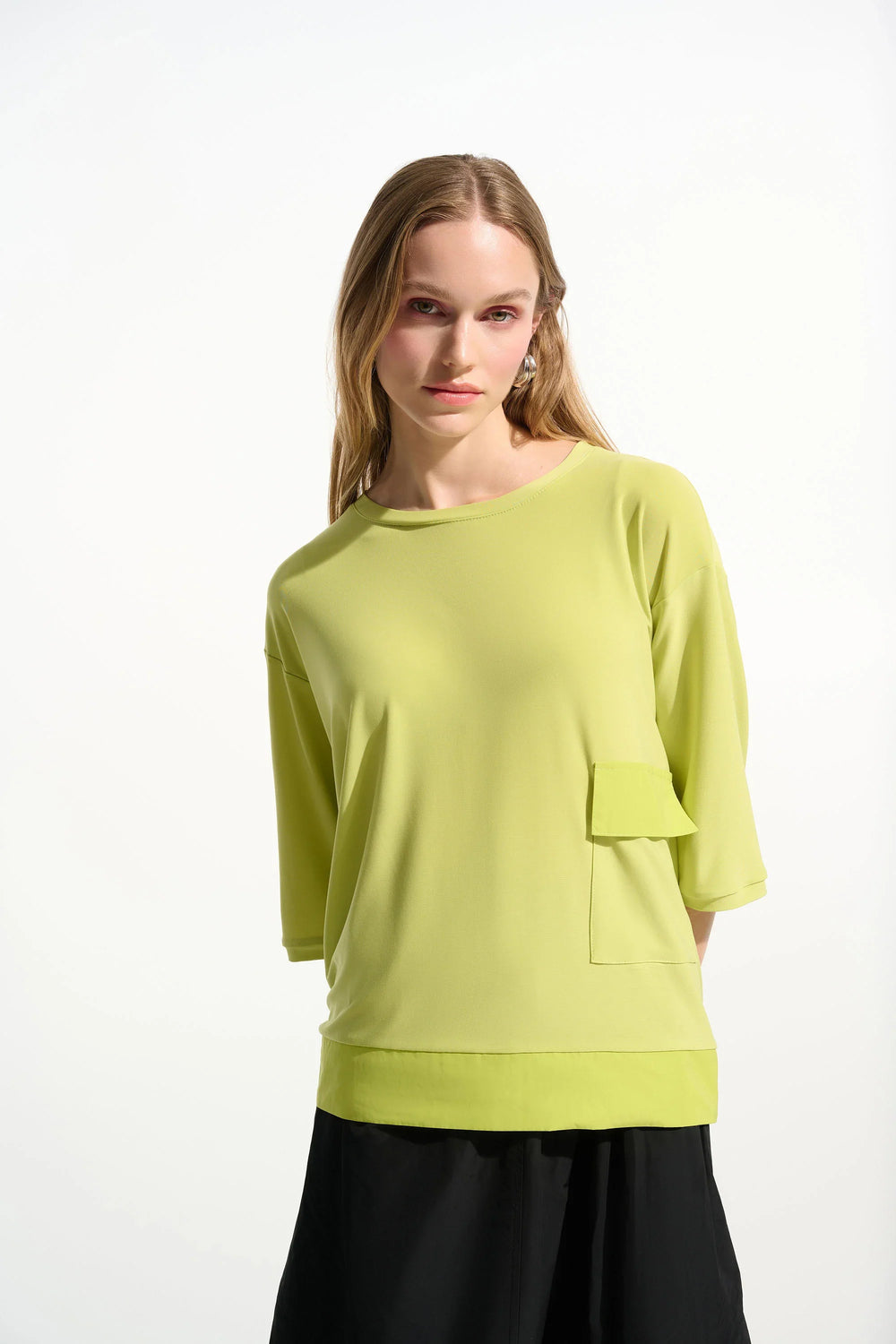 Light yellow-green boxy tunic with three-quarter sleeves and front pocket detail on model