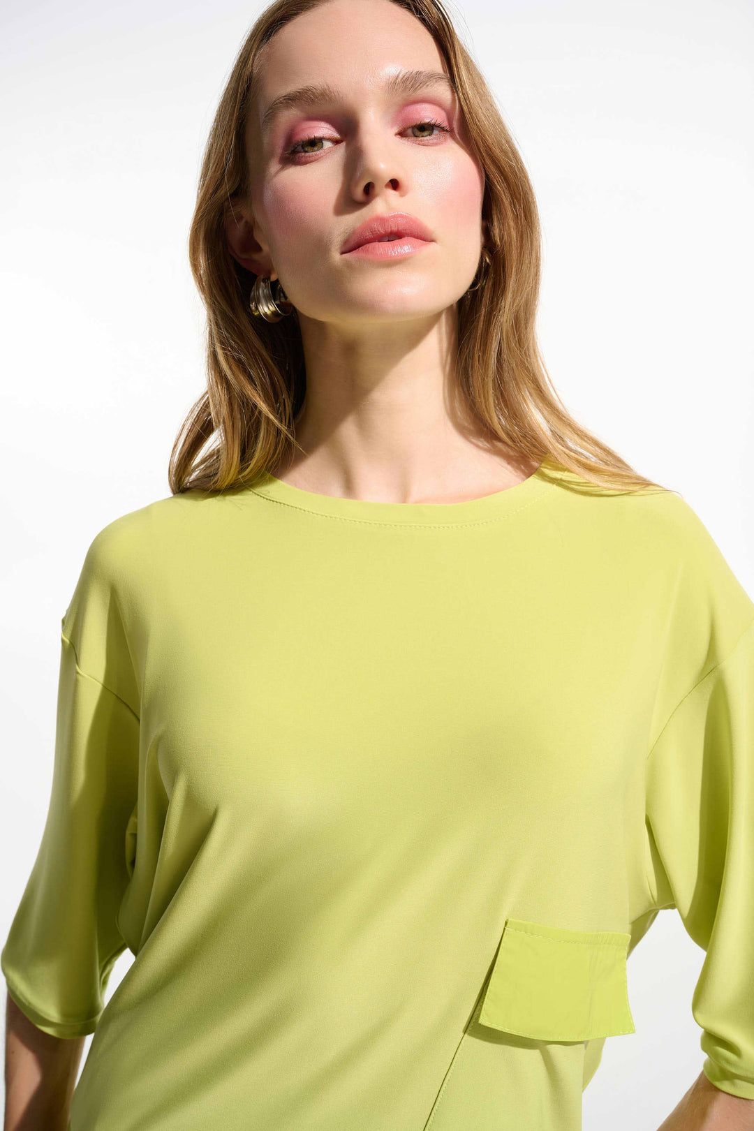 Lime green long-sleeve tunic with chest pocket detail on model