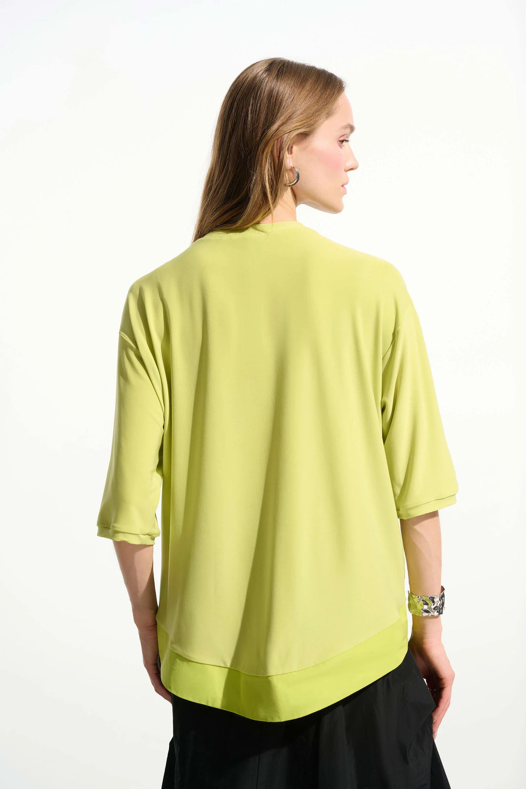 Lime green boxy tunic with three-quarter sleeves shown from back view on model