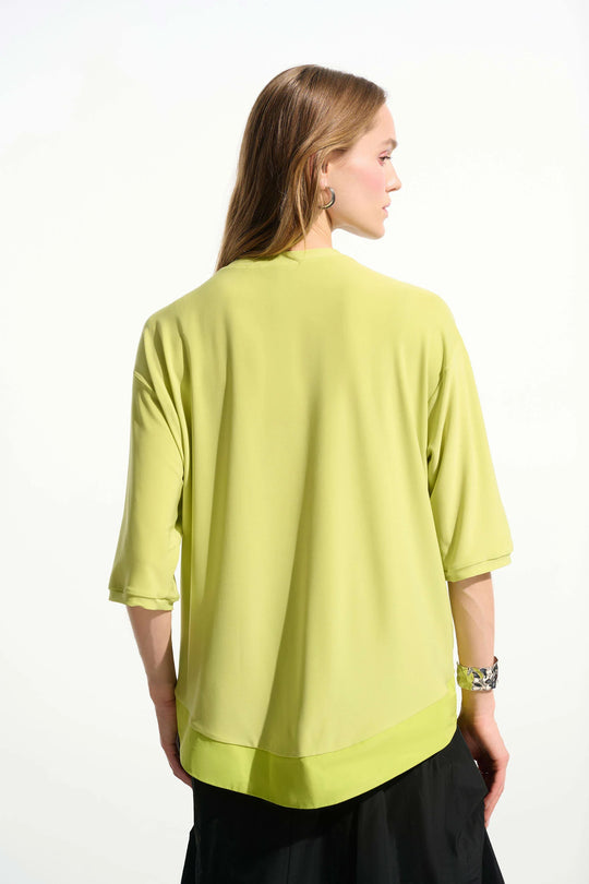 Lime green boxy tunic with three-quarter sleeves shown from back view on model