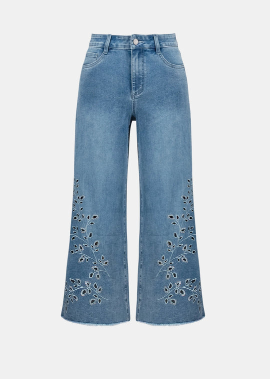 Blue jeans with floral embroidery on a white background