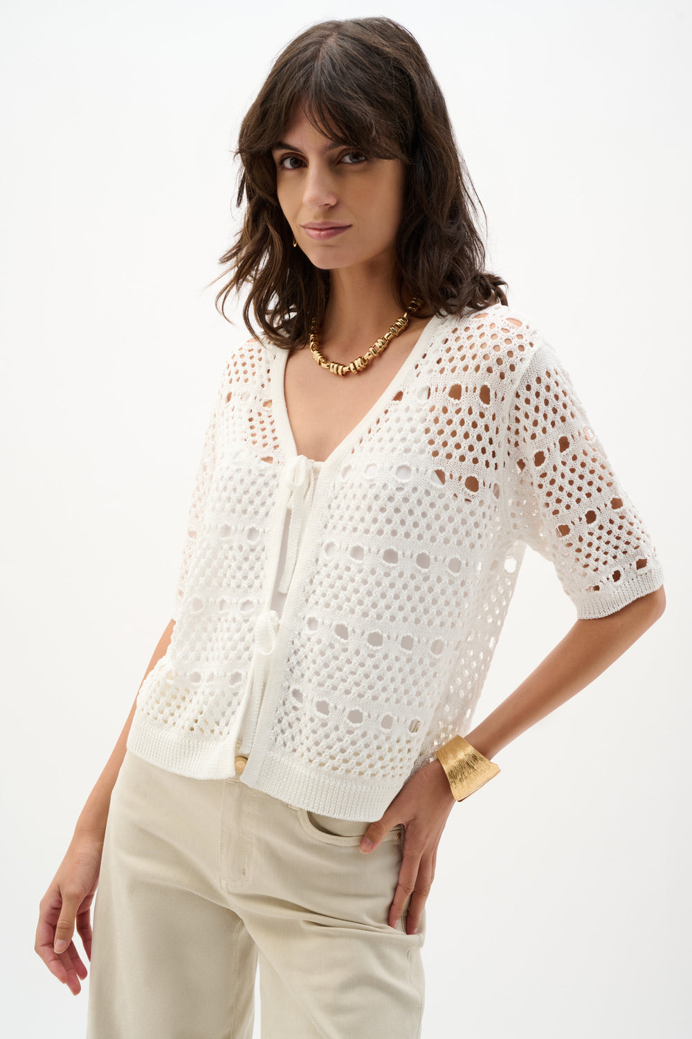 Cream open-stitch knit cardigan with short sleeves worn by model on white background