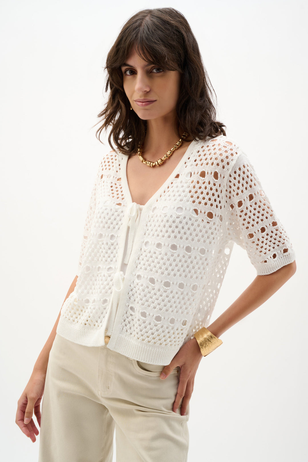 Cream open-stitch knit cardigan with short sleeves worn by model on white background