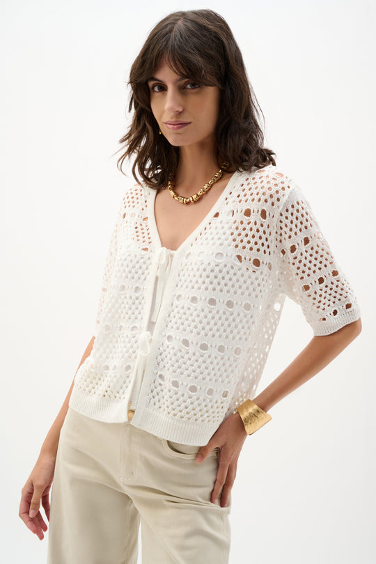 Cream open-stitch knit cardigan with short sleeves worn by model on white background