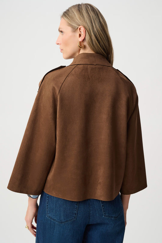 Brown back-view jacket with wide cape-like sleeves and structured yoke